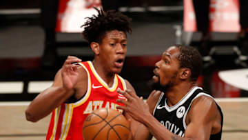 NEW YORK, NEW YORK - JANUARY 01: (NEW YORK DAILIES OUT) Kevin Durant #7 of the Brooklyn Nets in action against De'Andre Hunter #12 of the Atlanta Hawks at Barclays Center on January 01, 2021 in New York City. The Hawks defeated the Nets 114-96. NOTE TO USER: User expressly acknowledges and agrees that, by downloading and/or using this Photograph, user is consenting to the terms and conditions of the Getty Images License Agreement. (Photo by Jim McIsaac/Getty Images)