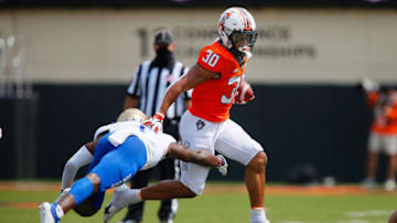 STILLWATER, OK - SEPTEMBER 19: Running back Chuba Hubbard #30 of the Oklahoma State Cowboys gets tripped up by safety Kendarin Ray #1 of the Tulsa Golden Hurricanes in the third quarter on September 19, 2020 at Boone Pickens Stadium in Stillwater, Oklahoma. (Photo by Brian Bahr/Getty Images)