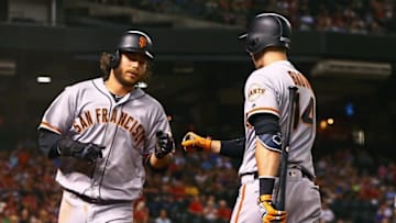 Jul 1, 2016; Phoenix, AZ, USA; San Francisco Giants shortstop Brandon Crawford (left) celebrates with catcher Trevor Brown after scoring in the second inning against the Arizona Diamondbacks at Chase Field. Mandatory Credit: Mark J. Rebilas-USA TODAY Sports