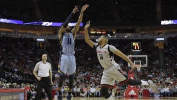 HOUSTON, TX - JANUARY 13: Mike Conley #11 of the Memphis Grizzlies shoots a three point shot defended by Eric Gordon #10 of the Houston Rockets in the second half at Toyota Center on January 13, 2017 in Houston, Texas. NOTE TO USER: User expressly acknowledges and agrees that, by downloading and or using this photograph, User is consenting to the terms and conditions of the Getty Images License Agreement. (Photo by Tim Warner/Getty Images)