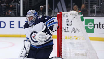 LOS ANGELES, CALIFORNIA - OCTOBER 28: Eric Comrie #1 of the Winnipeg Jets reacts to a shot during a 3-2 Jets win over the Los Angeles Kings at Staples Center on October 28, 2021 in Los Angeles, California. (Photo by Harry How/Getty Images)