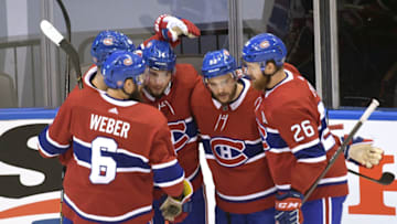 Aug 21, 2020; Toronto, Ontario, CAN; Montreal Canadiens center Nick Suzuki (14) celebrates with right wing Joel Armia (40) and defenseman Shea Weber (6) and left wing Jonathan Drouin (92) and defenseman Jeff Petry (26) after scoring a goal against the Philadelphia Flyers during the first period in game six of the first round of the 2020 Stanley Cup Playoffs at Scotiabank Arena. Mandatory Credit: Dan Hamilton-USA TODAY Sports