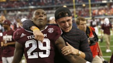 Sep 27, 2014; Arlington, TX, USA; Texas A&M Aggies cornerback Deshazor Everett (29) celebrates with former quarterback Johnny Manziel after a overtime victory against the Arkansas Razorbacks at AT&T Stadium. The Aggies beat the Razorbacks 35-28 in overtime. Mandatory Credit: Matthew Emmons-USA TODAY Sports