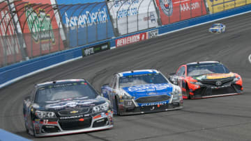 FONTANA, CA - MARCH 26: Jeffery Earnhardt (33), Danica Patrick (10) and Martin Truex Jr (78) goes three wide around turn 2 during the Monster Energy Cup Series 20th Anniversary Auto Club 400 at Auto Club Speedway in Fontana, California on March 26, 2017 (Photo by Joshua Lavallee/Icon Sportswire via Getty Images)