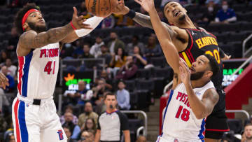 Mar 7, 2022; Detroit, Michigan, USA; Atlanta Hawks forward John Collins (20) reaches for the ball against Detroit Pistons forward Saddiq Bey (41) and guard Cory Joseph (18) during the first quarter at Little Caesars Arena. Mandatory Credit: Raj Mehta-USA TODAY Sports