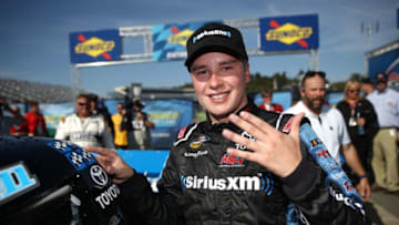 LOUDON, NH - SEPTEMBER 23: Christopher Bell, driver of the #4 SiriusXM Toyota, affixes the winners decal to his truck in Victory Lane after winning the NASCAR Camping World Truck Series UNOH 175 at New Hampshire Motor Speedway on September 23, 2017 in Loudon, New Hampshire. (Photo by Chris Graythen/Getty Images)