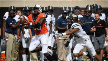 Sep 17, 2016; Stillwater, OK, USA; Oklahoma State Cowboys wide receiver James Washington (28) makes a catch as Pittsburgh Panthers defensive back Avonte Maddox (14) defends during the first half at Boone Pickens Stadium. Mandatory Credit: Rob Ferguson-USA TODAY Sports
