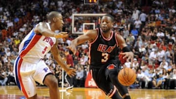 Feb 3, 2014; Miami, FL, USA; Miami Heat shooting guard Dwyane Wade (3) drives to the basket as Detroit Pistons shooting guard Kentavious Caldwell-Pope (5) defends during the second half at American Airlines Arena. Mandatory Credit: Steve Mitchell-USA TODAY Sports