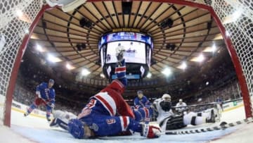 Jun 9, 2014; New York, NY, USA; New York Rangers defenseman Dan Girardi (5) falls over the back of goalie Henrik Lundqvist (rear) and sweeps the puck off the goal line against the Los Angeles Kings during the third period in game three of the 2014 Stanley Cup Final at Madison Square Garden. Mandatory Credit: Bruce Bennett/Pool Photo via USA TODAY Sports