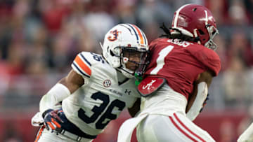 Auburn footballNov 26, 2022; Tuscaloosa, Alabama, USA; Auburn Tigers cornerback Jaylin Simpson (36) grabs Alabama Crimson Tide running back Jahmyr Gibbs (1) during the first half at Bryant-Denny Stadium. Mandatory Credit: Marvin Gentry-USA TODAY Sports
