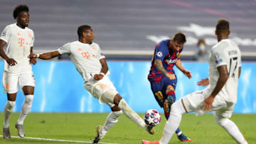 LISBON, PORTUGAL - AUGUST 14: Lionel Messi of FC Barcelona shoots past David Alaba of FC Bayern Munich during the UEFA Champions League Quarter Final match between Barcelona and Bayern Munich at Estadio do Sport Lisboa e Benfica on August 14, 2020 in Lisbon, Portugal. (Photo by Rafael Marchante/Pool via Getty Images)