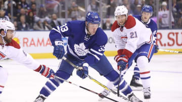 Oct 2, 2016; Toronto, Ontario, CAN; Toronto Maple Leafs forward Frederik Gauthier (33) tries to control the puck against the Montreal Canadiens during a preseason hockey game at Air Canada Centre. The Maple Leafs beat the Canadiens 3-2 in overtime. Mandatory Credit: Tom Szczerbowski-USA TODAY Sports