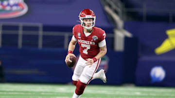 Dec 30, 2020; Arlington, TX, USA; Oklahoma Sooners quarterback Spencer Rattler (7) rolls out during the fourth quarter against the Florida Gators at ATT Stadium. Mandatory Credit: Tim Heitman-USA TODAY Sports