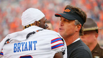 STILLWATER, OK - OCTOBER 14: Head coach Mike Gundy of the Oklahoma State Cowboys talks with cornerback Cobee Bryant #2 of the Kansas Jayhawks after their game at Boone Pickens Stadium on October 14, 2023 in Stillwater, Oklahoma. Oklahoma State won 39-32. (Photo by Brian Bahr/Getty Images)