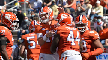 Oct 17, 2020; Atlanta, GA, USA; Clemson Tigers defensive tackle Nyles Pinckney (44) celebrates with Clemson Tigers quarterback Trevor Lawrence (16) after he scored a touchdown during the first half of an NCAA college football game at Bobby Dodd Stadium. Mandatory Credit: Hyosub Shin/Pool Photo-USA TODAY Sports