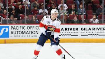 GLENDALE, AZ - FEBRUARY 26: Riley Stillman #70 of the Florida Panthers skates the puck up ice against the Arizona Coyotes at Gila River Arena on February 26, 2019 in Glendale, Arizona. The game marked Stillman's first career NHL game. (Photo by Norm Hall/NHLI via Getty Images)