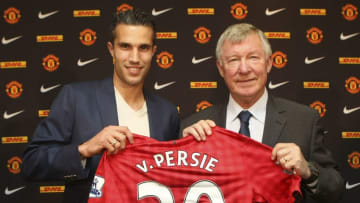 MANCHESTER, ENGLAND - AUGUST 17: Robin van Persie (L) and Manager Sir Alex Ferguson of Manchester United pose with a Manchester United shirt after van Persie signed a four year contract with the club at Old Trafford on August 17, 2012 in Manchester, England. (Photo by John Peters/Man Utd via Getty Images)