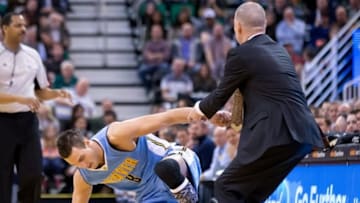 Feb 3, 2016; Salt Lake City, UT, USA; Denver Nuggets head coach Michael Malone helps forward Danilo Gallinari (8) up from the court during the first half against the Utah Jazz at Vivint Smart Home Arena. Mandatory Credit: Russ Isabella-USA TODAY Sports