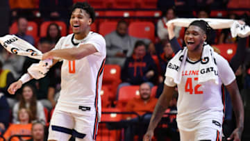 Dec 29, 2022; Champaign, Illinois, USA; Illinois Fighting Illini guard Terrence Shannon Jr. (0) and teammate Dain Dainja (42) react while watching teammates score during the second half against the Bethune-Cookman Wildcats at State Farm Center. Mandatory Credit: Ron Johnson-USA TODAY Sports