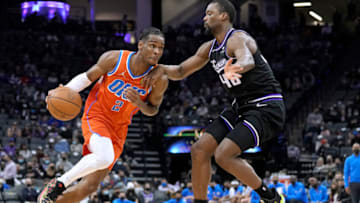 Shai Gilgeous-Alexander #2 of the Oklahoma City Thunder drives to the basket on Harrison Barnes #40 of the Sacramento Kings during the fourth quarter at Golden 1 Center on December 28, 2021 in Sacramento, California. NOTE TO USER: User expressly acknowledges and agrees that, by downloading and or using this photograph, User is consenting to the terms and conditions of the Getty Images License Agreement. (Photo by Thearon W. Henderson/Getty Images)