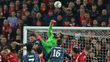 Liverpool's Brazilian goalkeeper Alisson Becker (C) punches the ball clear during the English League Cup semi-final first leg football match between Liverpool and Arsenal at Anfield in Liverpool, north west England on January 13, 2022. - - RESTRICTED TO EDITORIAL USE. No use with unauthorized audio, video, data, fixture lists, club/league logos or 'live' services. Online in-match use limited to 120 images. An additional 40 images may be used in extra time. No video emulation. Social media in-match use limited to 120 images. An additional 40 images may be used in extra time. No use in betting publications, games or single club/league/player publications. (Photo by Paul ELLIS / AFP) / RESTRICTED TO EDITORIAL USE. No use with unauthorized audio, video, data, fixture lists, club/league logos or 'live' services. Online in-match use limited to 120 images. An additional 40 images may be used in extra time. No video emulation. Social media in-match use limited to 120 images. An additional 40 images may be used in extra time. No use in betting publications, games or single club/league/player publications. / RESTRICTED TO EDITORIAL USE. No use with unauthorized audio, video, data, fixture lists, club/league logos or 'live' services. Online in-match use limited to 120 images. An additional 40 images may be used in extra time. No video emulation. Social media in-match use limited to 120 images. An additional 40 images may be used in extra time. No use in betting publications, games or single club/league/player publications. (Photo by PAUL ELLIS/AFP via Getty Images)