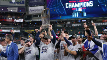 Nov 2, 2021; Houston, TX, USA; Atlanta Braves manager Brian Snitker hoists the Commissioner's Trophy after defeating the Houston Astros in game six of the 2021 World Series at Minute Maid Park. Mandatory Credit: Troy Taormina-USA TODAY Sports