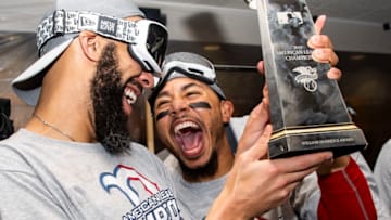 HOUSTON, TX - OCTOBER 18: David Price #24 and Mookie Betts #50 of the Boston Red Sox celebrate with the American League Championship Series trophy in the clubhouse after clinching the American League Championship Series in game five against the Houston Astros on October 18, 2018 at Minute Maid Park in Houston, Texas. (Photo by Billie Weiss/Boston Red Sox/Getty Images)