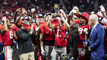 ATLANTA, GA - DECEMBER 3: Stetson Bennett #13 of the Georgia Bulldogs celebrates the MVP Award after a game between LSU Tigers and Georgia Bulldogs at Mercedes-Benz Stadium on December 3, 2022 in Atlanta, Georgia. (Photo by Steve Limentani/ISI Photos/Getty Images)