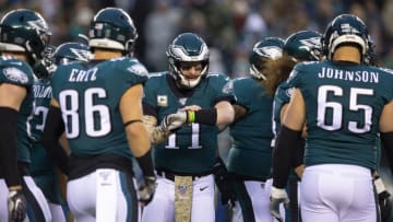 PHILADELPHIA, PA - NOVEMBER 17: Dallas Goedert #88, Zach Ertz #86, Carson Wentz #11, and Lane Johnson #65 of the Philadelphia Eagles huddle against the New England Patriots at Lincoln Financial Field on November 17, 2019 in Philadelphia, Pennsylvania. (Photo by Mitchell Leff/Getty Images)