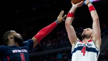 Feb 22, 2015; Auburn Hills, MI, USA; Washington Wizards center Marcin Gortat (4) shoots over Detroit Pistons center Andre Drummond (0) during the second quarter at The Palace of Auburn Hills. Mandatory Credit: Tim Fuller-USA TODAY Sports