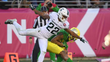 SANTA CLARA, CA - DECEMBER 31: Dillon Mitchell #13 of the Oregon Ducks catches a touchdown pass over Josiah Scott #22 of the Michigan State Spartans during the second half of the Redbox Bowl at Levi's Stadium on December 31, 2018 in Santa Clara, California. (Photo by Thearon W. Henderson/Getty Images)