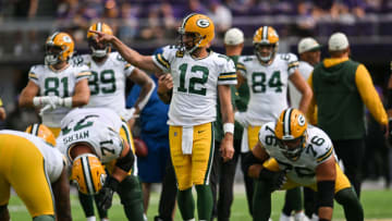 Sep 11, 2022; Minneapolis, Minnesota, USA; Green Bay Packers quarterback Aaron Rodgers (12) and center Josh Myers (71) and guard Jon Runyan (76) in action before the game against the Minnesota Vikings at U.S. Bank Stadium. Mandatory Credit: Jeffrey Becker-USA TODAY Sports
