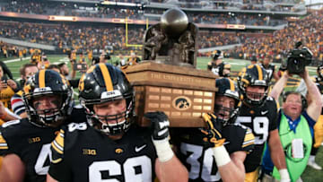 IOWA CITY, IOWA- SEPTEMBER 08: Offensive lineman Keegan Render #69 and defensive back Jake Gervase #30 of the Iowa Hawkeyes carry the Cy-Hawk trophy after the match-up against the Iowa State Cyclones on September 8, 2018 at Kinnick Stadium, in Iowa City, Iowa. (Photo by Matthew Holst/Getty Images)
