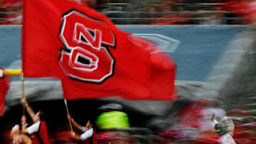 RALEIGH, NC - OCTOBER 01: NC State Mascot Ms. Wuf follows flag bearers after a score during the NC State Wolfpack football game against the Wake Forest Demon Deacons at Carter-Finley Stadium on October 1, 2016 in Raleigh, North Carolina. (Photo by Mike Comer/Getty Images)