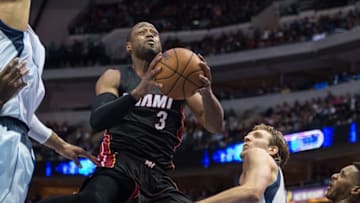 Nov 9, 2014; Dallas, TX, USA; Miami Heat guard Dwyane Wade (3) drives to the basket past Dallas Mavericks forward Dirk Nowitzki (41) during the second half at the American Airlines Center. The Heat defeated the Mavericks 105-96. Mandatory Credit: Jerome Miron-USA TODAY Sports