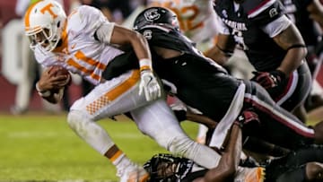 Oct 29, 2016; Columbia, SC, USA; Tennessee Volunteers quarterback Joshua Dobbs (11) is brought down by South Carolina Gamecocks defensive lineman Darius English (5) and South Carolina Gamecocks defensive lineman Dante Sawyer (95) in the second half at Williams-Brice Stadium. Mandatory Credit: Jeff Blake-USA TODAY Sports