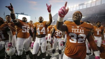 Oct 29, 2016; Austin, TX, USA; Texas Longhorns players Brando Hodges (58), Quincy Vasser (44), and Malcolm Roach (32) celebrate after defeating the Baylor Bears 35-34 at Darrell K Royal-Texas Memorial Stadium. Mandatory Credit: Erich Schlegel-USA TODAY Sports