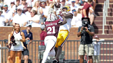 STARKVILLE, MISSISSIPPI - SEPTEMBER 16: Malik Nabers #8 of the LSU Tigers catches a touchdown pass against Hunter Washington #21 of the Mississippi State Bulldogs during the first half at Davis Wade Stadium on September 16, 2023 in Starkville, Mississippi. (Photo by Justin Ford/Getty Images)