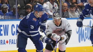 TORONTO, CANADA - OCTOBER 31: Trevor Moore #12 of the Los Angeles Kings tries to check John Klingberg #3 of the Toronto Maple Leafs during the first period in an NHL game at Scotiabank Arena on October 31, 2023 in Toronto, Ontario, Canada. (Photo by Claus Andersen/Getty Images)