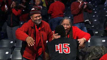 Jan 7, 2017; Atlanta, GA, USA; Louisville Cardinals guard Donovan Mitchell (45) celebrates with his uncle Michael Hairston and grandmother Blossom Wright after the Cardinals win against the Georgia Tech Yellow Jackets at McCamish Pavilion. The Cardinals won 65-50. Mandatory Credit: Jason Getz-USA TODAY Sports