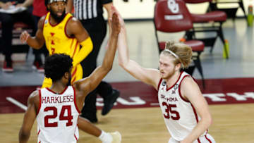 Feb 6, 2021; Norman, Oklahoma, USA; Oklahoma Sooners forward Brady Manek (35) and Oklahoma Sooners guard Elijah Harkless (24) celebrate after a basket against the Iowa State Cyclones during the second half at Lloyd Noble Center. Oklahoma won 79-72. Mandatory Credit: Alonzo Adams-USA TODAY Sports