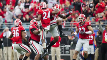 Jan 2, 2016; Jacksonville, FL, USA; Georgia Bulldogs safety Dominick Sanders (24) celebrates a interception with linebacker Natrez Patrick (6) and defensive back Rico McGraw (36) and defensive tackle James DeLoach (89) and tight end Jeb Blazevich (83) in the first quarter against the Penn State Nittany Lions at EverBank Field. Mandatory Credit: Logan Bowles-USA TODAY Sports