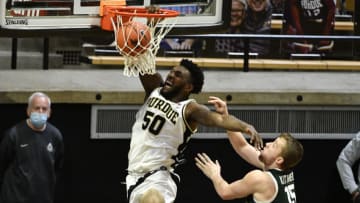 Feb 16, 2021; West Lafayette, Indiana, USA; Purdue Boilermakers forward Trevion Williams (50) dunks the ball in front of Michigan State Spartans forward Thomas Kithier (15) during the second half of the game at Mackey Arena. Mandatory Credit: Marc Lebryk-USA TODAY Sports