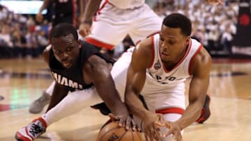 May 11, 2016; Toronto, Ontario, CAN; Toronto Raptors point guard Kyle Lowry (7) battles for a loose ball with Miami Heat forward Luol Deng (9) in game five of the second round of the NBA Playoffs at Air Canada Centre. Mandatory Credit: Tom Szczerbowski-USA TODAY Sports