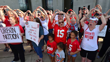 COLUMBUS, OH - AUGUST 6: Supporters of Ohio State head football coach Urban Meyer sing Carmen Ohio at a rally at Ohio State University on August 6, 2018 in Columbus, Ohio. Meyer is on paid administrative leave after a reports alleging he knew of a 2015 allegation of domestic violence against former assistant football coach Zach Smith, who was fired in July. (Photo by Jamie Sabau/Getty Images)