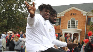 ATHENS, GA - JANUARY 15: Jordan Davis #99 of the Georgia Bulldogs reacts with fans during the parade honoring the Georgia Bulldogs national championship victory on January 15, 2022 in Athens, Georgia. (Photo by Todd Kirkland/Getty Images)
