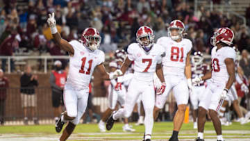 STARKVILLE, MISSISSIPPI - OCTOBER 16: Wide receiver Traeshon Holden #11 of the Alabama Crimson Tide celebrates with teammates after scoring a touchdown during the forth quarter of their game against the Mississippi State Bulldogs at Davis Wade Stadium on October 16, 2021 in Starkville, Mississippi. (Photo by Michael Chang/Getty Images)