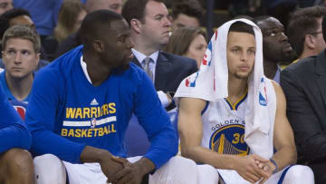 April 1, 2016; Oakland, CA, USA; Golden State Warriors forward Draymond Green (23, left) and guard Stephen Curry (30) look on against the Boston Celtics during the fourth quarter at Oracle Arena. The Celtics defeated the Warriors 109-106. Mandatory Credit: Kyle Terada-USA TODAY Sports