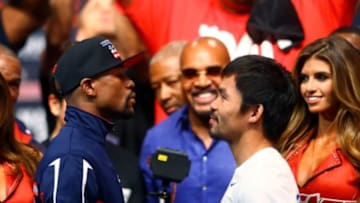 May 1, 2015; Las Vegas, NV, USA; Floyd Mayweather (left) stares at Manny Pacquiao during weigh-ins for the upcoming boxing fight at MGM Grand Garden Arena. Mandatory Credit: Mark J. Rebilas-USA TODAY Sports