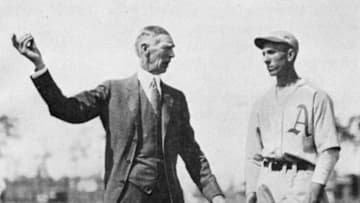 LAKE CHARLES, LOUISIANA - MARCH, 1920. Connie Mack, left, shows a Philadelphia Athletics rookie the finer points of pitching at spring training in Lake Charles, Louisiana in March of 1920. (Photo by Mark Rucker/Transcendental Graphics, Getty Images)